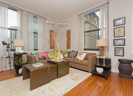 a living room with a brown couch and a large window
