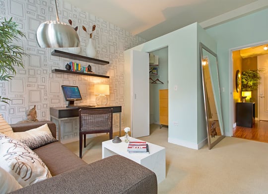 a living room with a couch and a desk