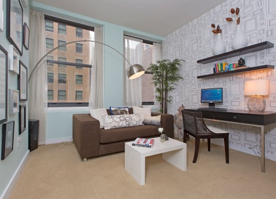 a living room with a couch and a desk
