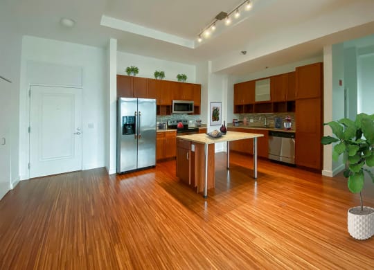 a kitchen with stainless steel appliances and a wooden floor