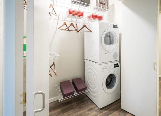 a white laundry room with a washing machine and a dryer
