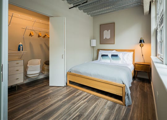a bedroom with a bed and a bathroom with a shower
