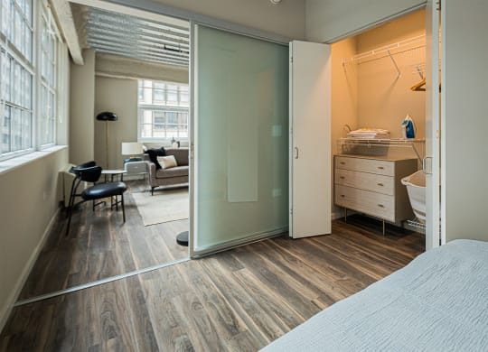 a bedroom with a bed and a bathroom with a sliding glass door