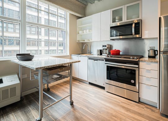 a kitchen with stainless steel appliances and a table