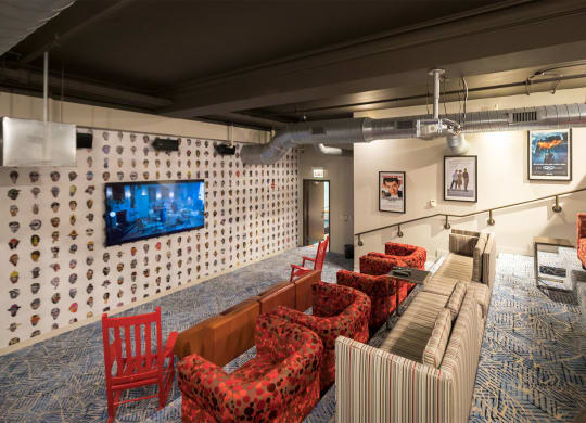 a living room with couches and chairs and a television on the wall