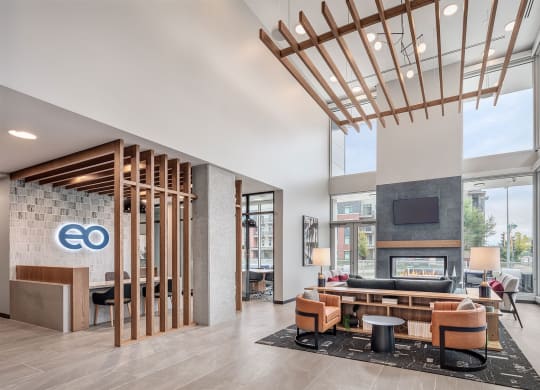 the lobby of a hotel with a couch and a fireplace