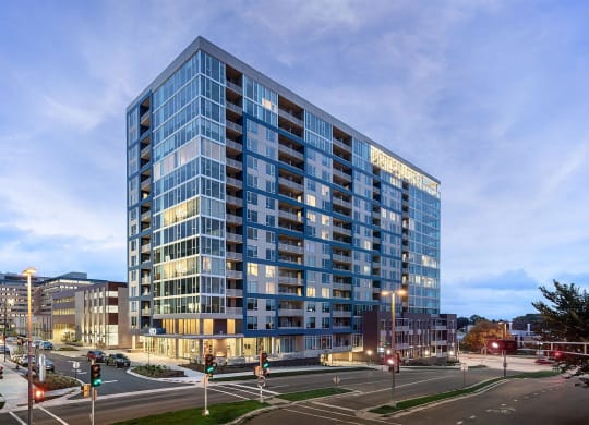 an apartment building on a city street at dusk