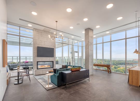 a living room with a fireplace and large windows
