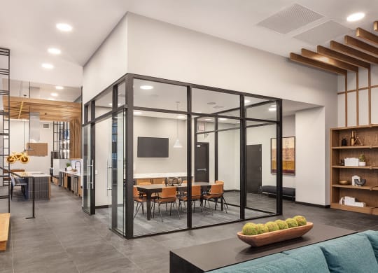 a conference room with glass walls and a table and chairs