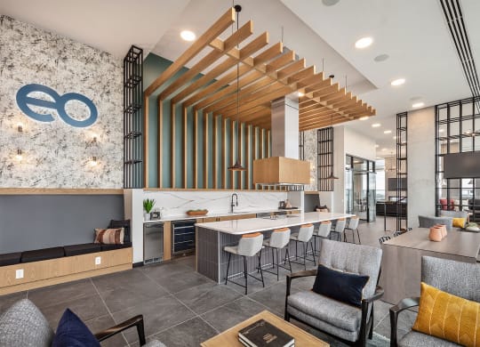 a clubhouse with a bar and chairs and a lobby with a table and chairs
