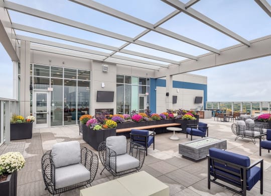a terrace with chairs and tables and a large glass roof