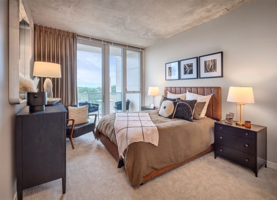 a bedroom with a bed and a large window