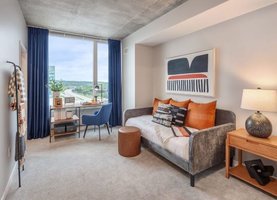 a bedroom with a bed and a desk with a window