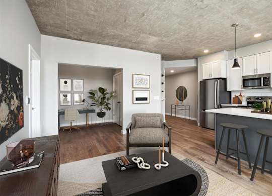 A modern living room with a grey armchair and a coffee table in the center.