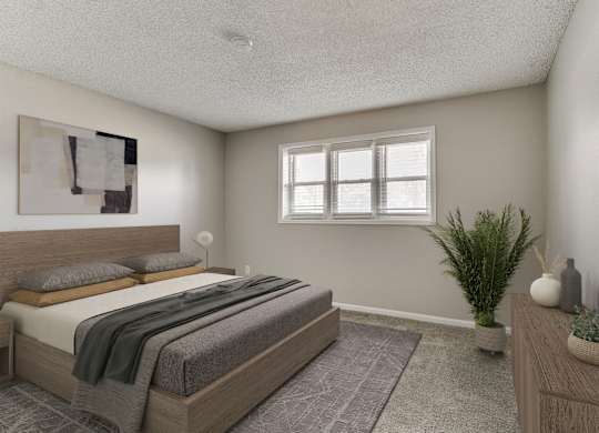 A bedroom with a large bed and a potted plant.