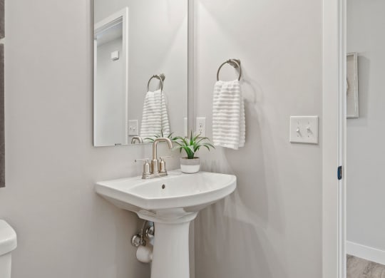 a white bathroom with a sink and a mirror
