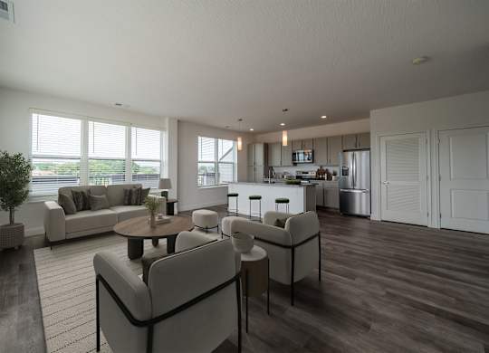 A modern living room with a grey sofa set and a wooden floor.