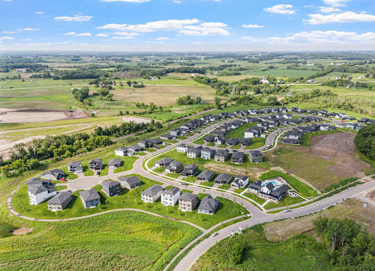 A bird's eye view of a residential area with houses and roads.