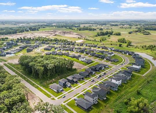 A bird's eye view of a residential area with houses and greenery.