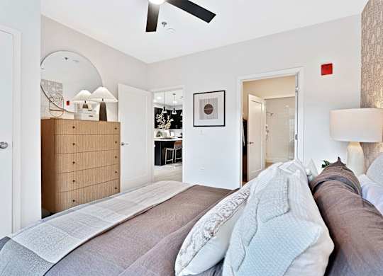 A bedroom with a bed, dresser, and mirror.
