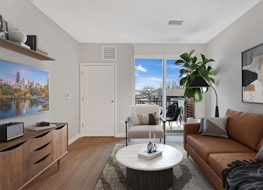 A living room with a brown couch, a coffee table, and a painting on the wall.