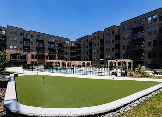 A large building with a pool in front.