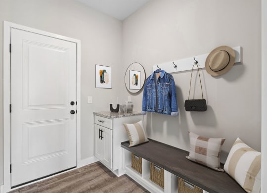 a bedroom with a dresser and a hat on the wall