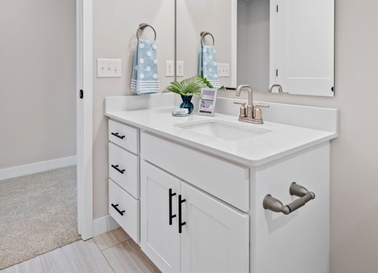 a white bathroom with a sink and a mirror