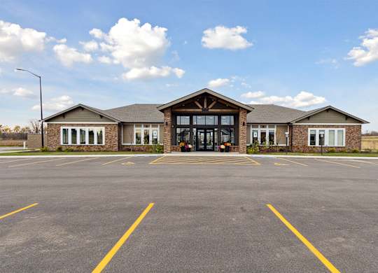 A building with a parking lot in front of it.