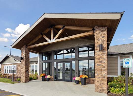 A building with a covered entrance and a sign that says