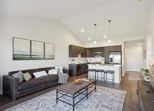 A modern living room with a grey couch and a coffee table.