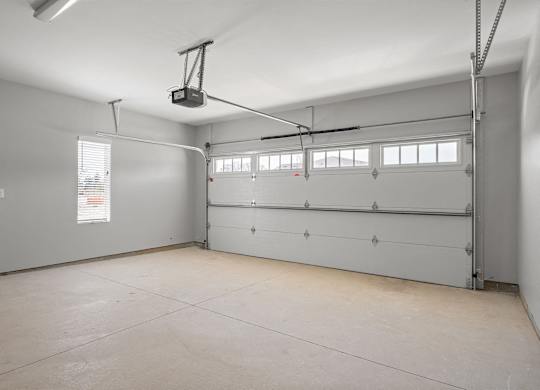 A spacious garage with a lift system installed.
