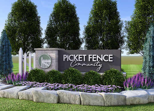 A sign that says Pickett Fence Community in front of trees.