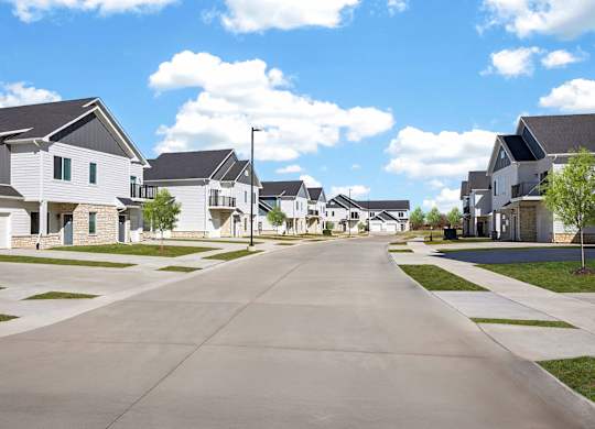 A row of houses with a street in between.