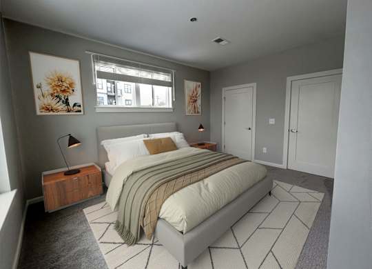 A bedroom with a bed, nightstand, and two pictures on the wall.
