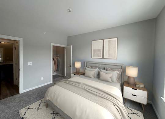 A bedroom with a large bed, two nightstands, and a rug.