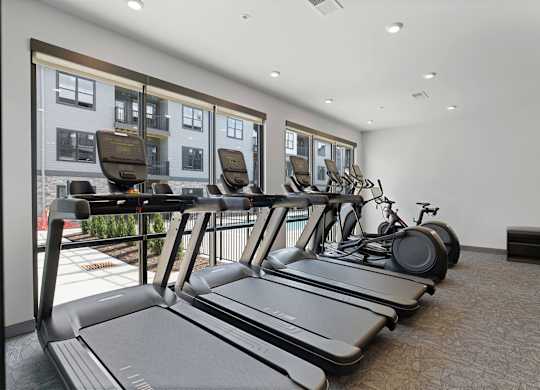 A gym with treadmills and exercise bikes.