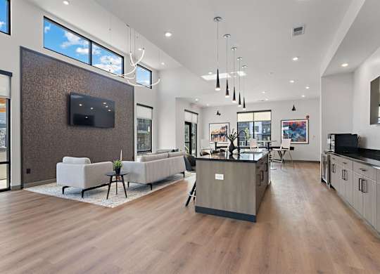 A modern living room with a flat screen TV mounted on the wall.