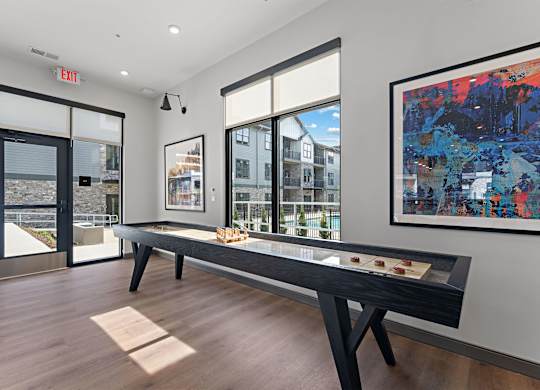 A room with a table and a painting on the wall.