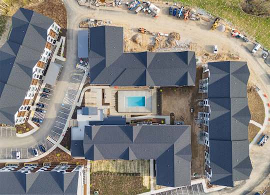 A large building with a pool in the middle of it.