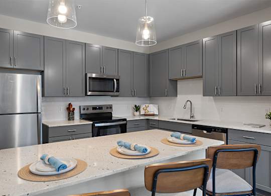 A kitchen with a table set for two.