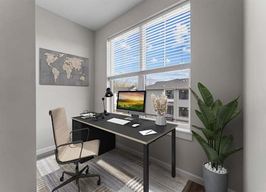 A modern home office with a desk, chair, and a world map on the wall.