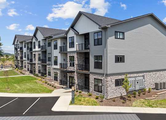 A row of modern townhouses with a clear blue sky above.
