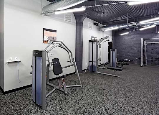 A gym with a variety of equipment including a leg press machine.