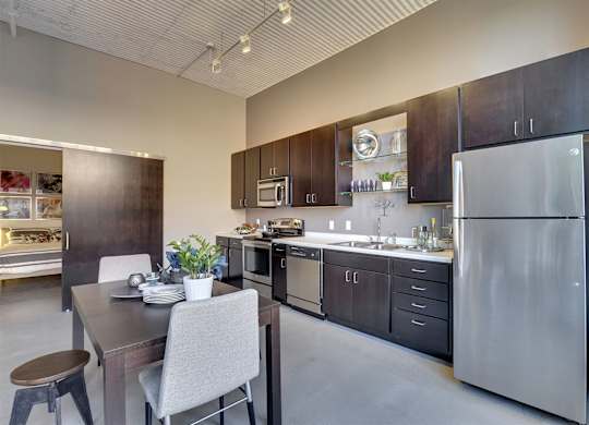 A modern kitchen with a dining table and chairs.