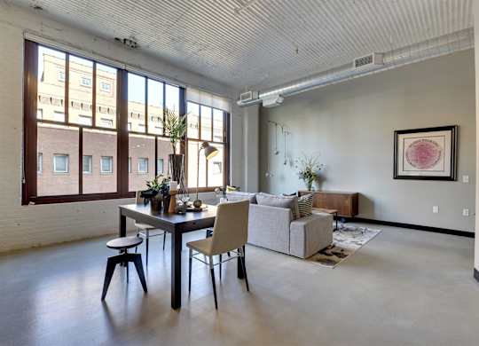 A dining room with a table and chairs.