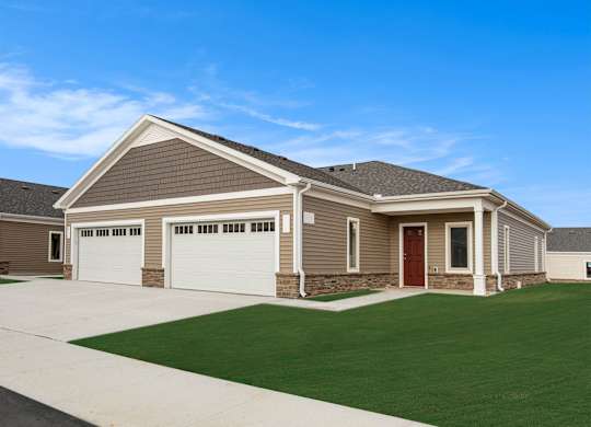 A house with a brown roof and a red door.