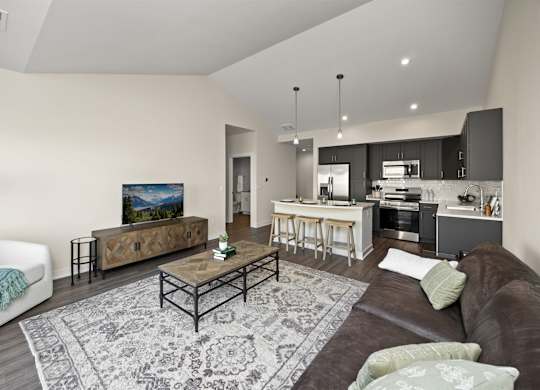 A modern living room with a brown couch and a coffee table.
