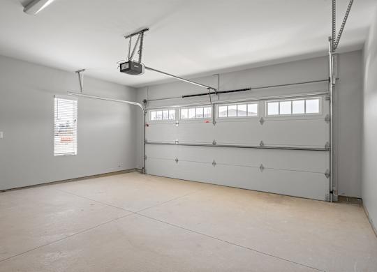 A spacious garage with a lift system installed.