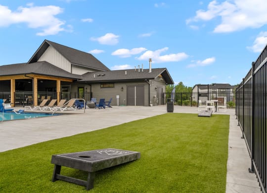 the backyard of a house with a pool and a fire pit